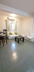 a living room with white couches and a table at San Lorenzo - Bon Repos in San Miguel de Tucumán