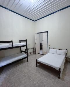 a bedroom with two bunk beds and a window at Casarão Central in Carolina