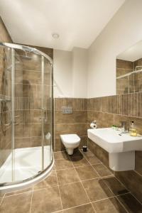 a bathroom with a shower and a sink and a toilet at Escape Ordinary at Castle Hume in Enniskillen