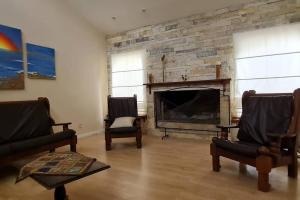 a living room with two chairs and a fireplace at Casa quinta en la ruta 1 km 3.5 in Santa Fe