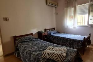 a bedroom with two beds and a window at Casa quinta en la ruta 1 km 3.5 in Santa Fe +5 photos