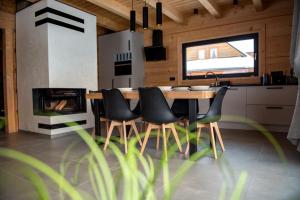 a kitchen with a table and chairs and a fireplace at Montana górska chata in Brenna