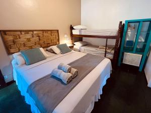 Cama ou camas em um quarto em Pousada Paloma