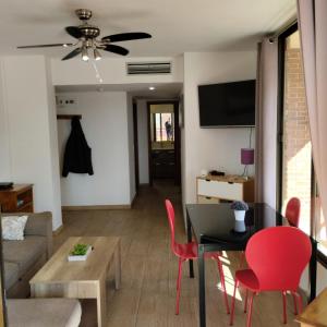 ベニドルムにあるCarlos V Levanteのリビングルーム(黒いテーブル、赤い椅子付)