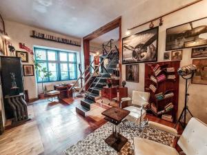 a living room with a spiral staircase in a room at Divná pani Luxury Gallery Rooms in Banská Štiavnica