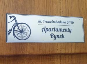 a sign on a wall with a bike on it at Apartament Azyl in Przemyśl