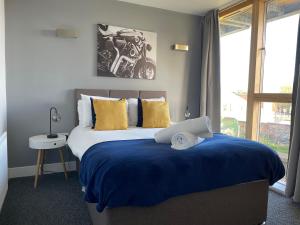 a bedroom with a large bed with a motorcycle on it at Coventry Luxury Townhouse City Centre Private Parking Sleeps 9 by EMPOWER HOMES in Coventry