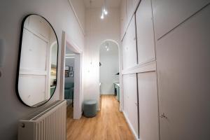 pasillo con espejo grande y baño en Coente Apartments Király 28 en Budapest