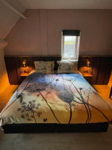 1 dormitorio con cama con edredón en B&B Hof 't Sprakel, en Haaksbergen