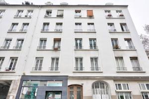 a large white building with windows and balconies at Nice apartment at 10 min from Bastille in Paris