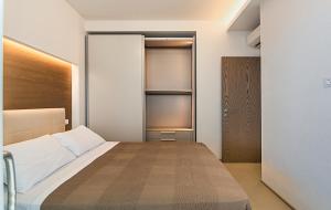 a bedroom with a bed and a closet at Sea Holidays Apartment in Marina di Pietrasanta