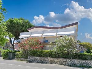 a house with a white awning on the side of a road at Sea Holidays Apartment in Marina di Pietrasanta