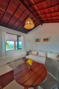 a living room with a table and a couch at Pousada Rota Ecológica in Pôrto de Pedras
