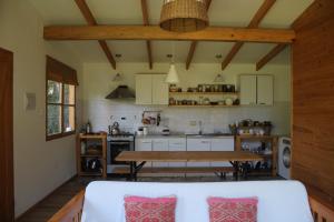 a kitchen with a table and a dining room at Acogedora casa a pasos de la playa-Couzy house next to the beach in La Serena
