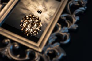 a close up of a mirror with a chandelier at Hotel Plas Hyfryd in Narberth