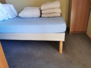 a bed with four pillows on top of it at APPARTEMENT 1 Chambre 5 Personnes L'OURS BLANC à L'ALPE D'HUEZ in L'Alpe-d'Huez +27 photos