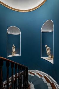 a staircase with two windows with a statue on them at Hotel Plas Hyfryd in Narberth