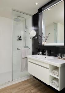 a bathroom with a white sink and a shower at INNSiDE by Meliá Barcelona Apolo in Barcelona