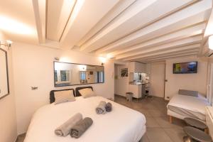 a bedroom with a large white bed in a room at Cannes Flat Rentals in Cannes