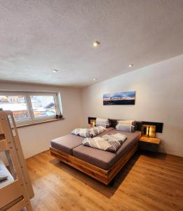a bedroom with a large bed with pillows on it at Mountain JoLe in Neustift im Stubaital