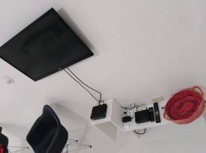 a tv on a wall with a red rope on it at Studio Aguero - Recoleta in Buenos Aires