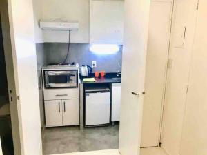 a small kitchen with a stove and a microwave at Studio Aguero - Recoleta in Buenos Aires