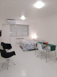 a bedroom with a bed and a table and chairs at Studio Aguero - Recoleta in Buenos Aires