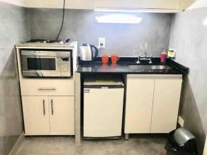 a small kitchen with a sink and a microwave at Studio Aguero - Recoleta in Buenos Aires +6 photos