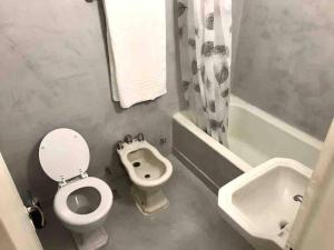 a bathroom with a toilet and a sink at Studio Aguero - Recoleta in Buenos Aires