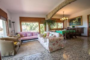 a living room with couches and a dining room at Catalunya Casas Mountain Escape with stunning views 40 km to Barna! in San Felíu del Racó