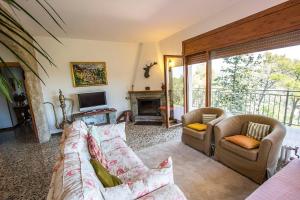 a living room with a couch and chairs and a television at Catalunya Casas Mountain Escape with stunning views 40 km to Barna! in San Felíu del Racó