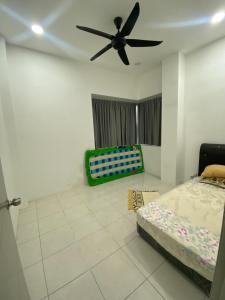 a bedroom with a bed and a ceiling fan at The Vista Apartment @ Demak Laut in Kuching