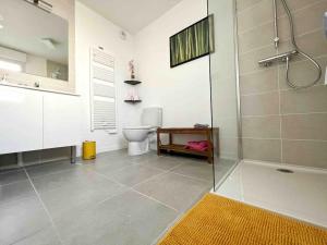 a bathroom with a shower and a toilet at La Rayon'Nantes in Carquefou +36 photos