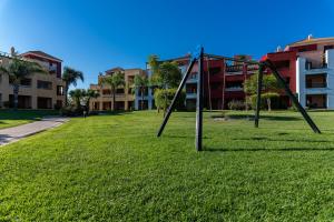een park met een lege schommel in het gras bij El Rincón del Golf III by Ĥ in Isla Canela