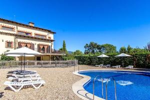 a villa with a swimming pool in front of a building at Catalunya Casas Nature and Tranquility for 24 pax - 30km to beach in Sant Pere de Vilamajor
