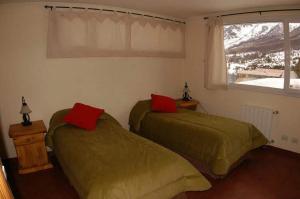 a bedroom with two green beds and a window at Las Asturianas in San Carlos de Bariloche +28 photos
