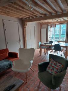a living room with a couch and chairs and a table at Un Brin de folie dans le centre de Honfleur in Honfleur