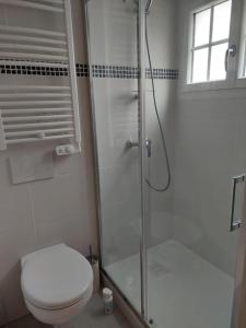 a bathroom with a toilet and a glass shower at Un Brin de folie dans le centre de Honfleur in Honfleur