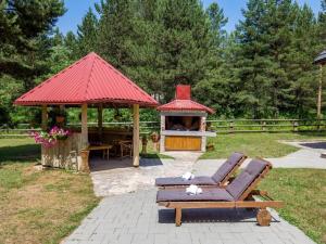 a gazebo with a bench and a gazebo with at Apartments Plitvice forest in Korenica