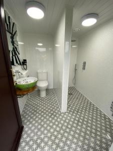 a bathroom with a toilet and a sink and a tub at Glamping Dome Elysian Fields in Helston +11 photos