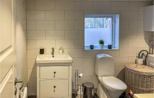 a bathroom with a toilet and a sink and a window at Nice Home In Tyringe With House A Panoramic View in Tyringe