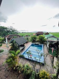 an overhead view of a swimming pool in front of a house at Dangau Sala D'Kontena in Alor Setar