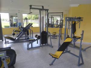 a gym with several tread machines in a room at Recanto de Araruama in Araruama