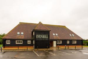 a large black building with a sign on it at The Evenhill in Canterbury
