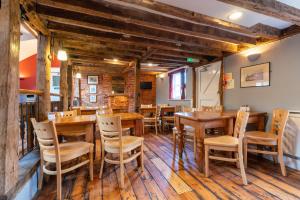 a dining room with wooden tables and chairs at The Evenhill in Canterbury
