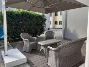 a patio with a table and chairs and an umbrella at Elegant house with a garden in Mira