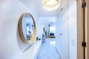 a hallway with a round mirror on a wall at Studio Marina View by Seewest in Lagos +19 photos