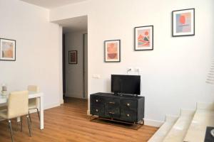a living room with a tv and a table with chairs at Casa con giardinetto al centro di Roma in Rome