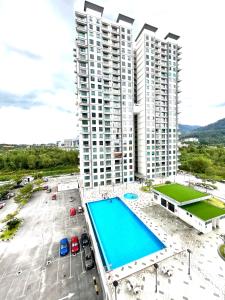 an aerial view of a large building with a swimming pool at Blossom - Casa Kayangan Meru Ipoh by GOSWELL in Ipoh