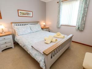a bedroom with a bed with two towels on it at Salakee in Penzance